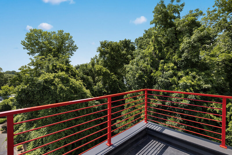 red railing of roof top deck in uptown Charlotte new construction home