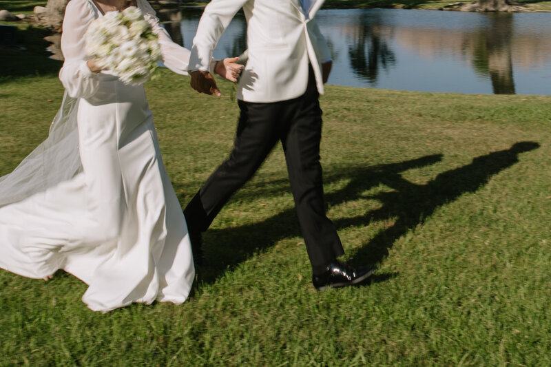 Payton and Evan running during sunset together after their wedding