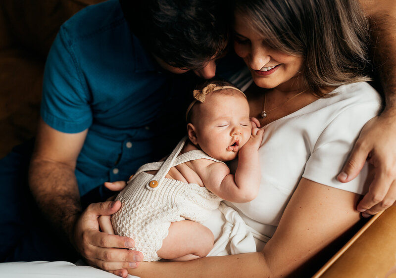 mom and dad holding baby during a newborn session