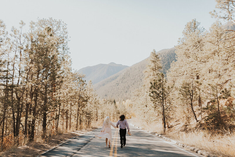 Couple runs through the mountains for their destination wedding in Colorado.