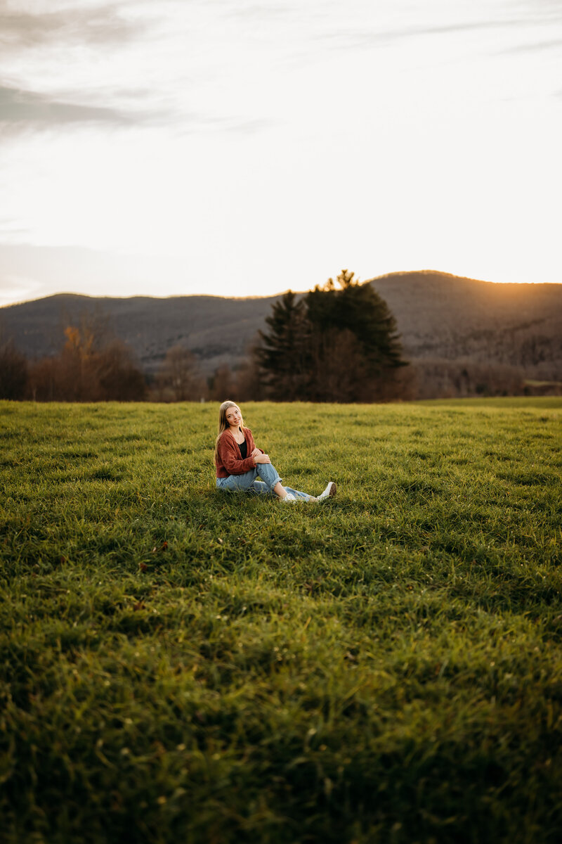 A senior girl bathed in the golden hour light, symbolizing the bright future ahead, captured in Vermont