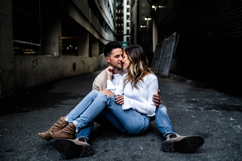 Luxury Portraits by Moving Mountains Photography in NC - Photo of a couple sitting  while leaning in towards each other