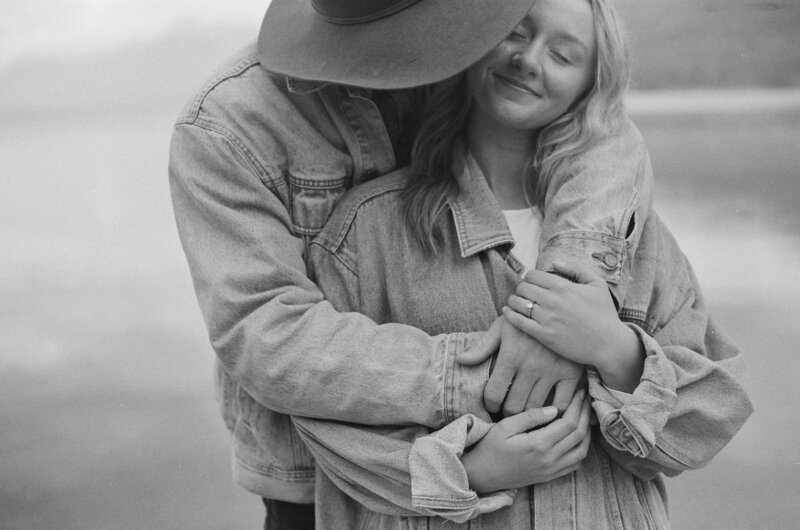 couple embracing as the husband kisses the wife's cheek