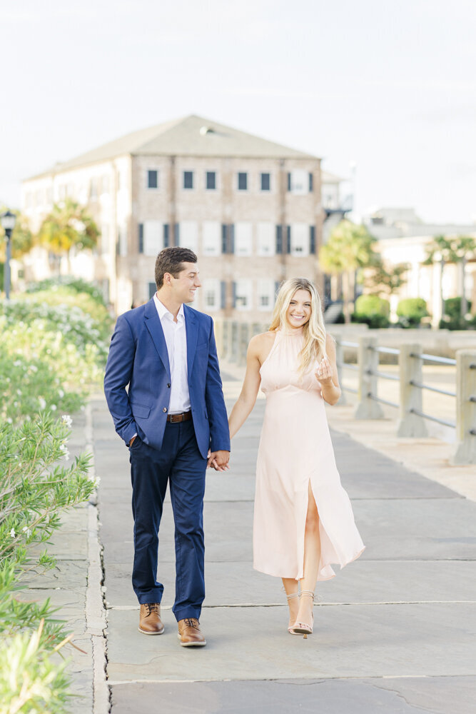 engaged couple walking in downtown Charleston