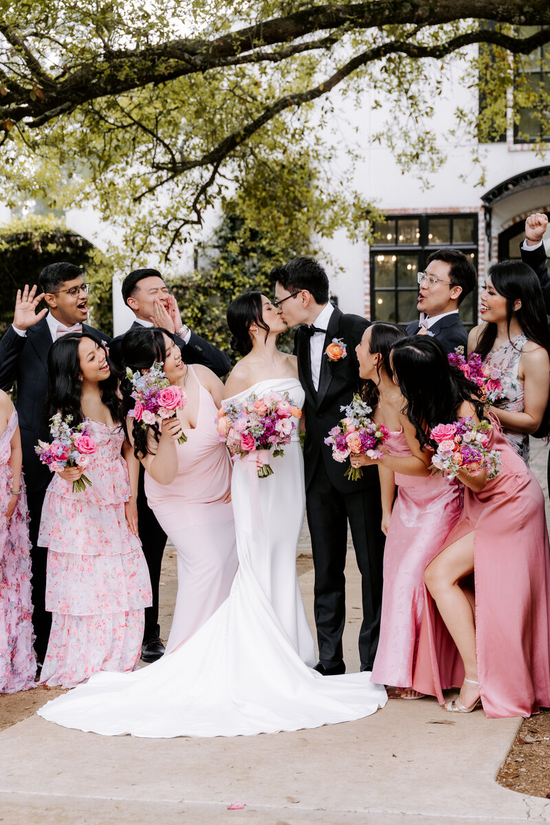 Bridal party cheering with bride and groom at a Houston wedding