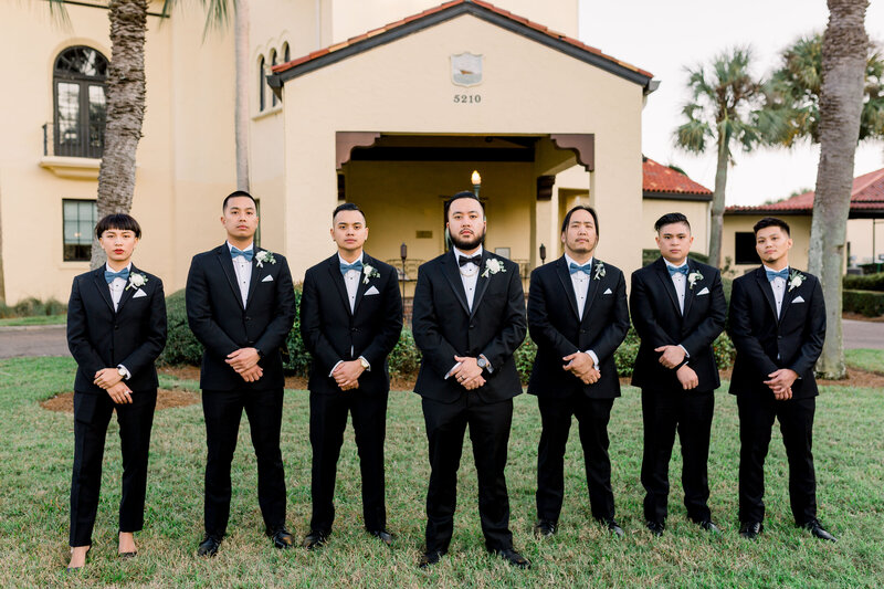 Groom poses with his guys and favorite girl
