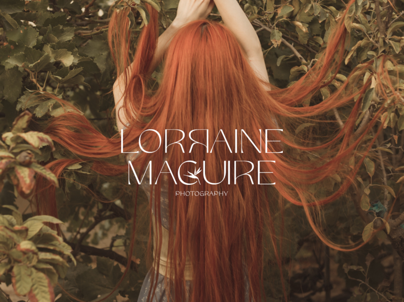 Long red hair flowing with a persons arms in the air, back to camera. The Lorraine Maguire Photography logo is over it