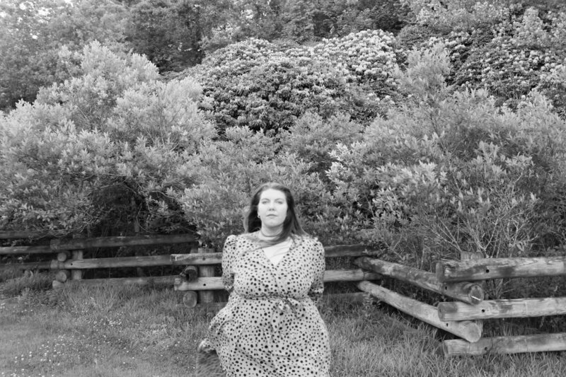 Ashleigh Henry standing with power and softness in Asheville, NC — coaching women who are healing from high-functioning survival into sacred presence.