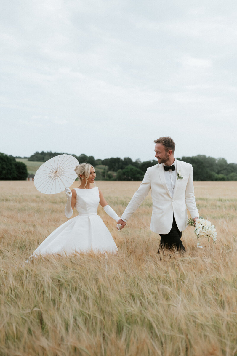 Bride and groom share quiet sunset moment during Norfolk wedding