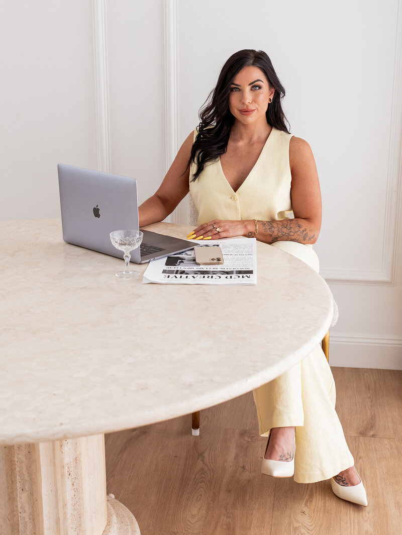 Woman in jeans sitting on the counter