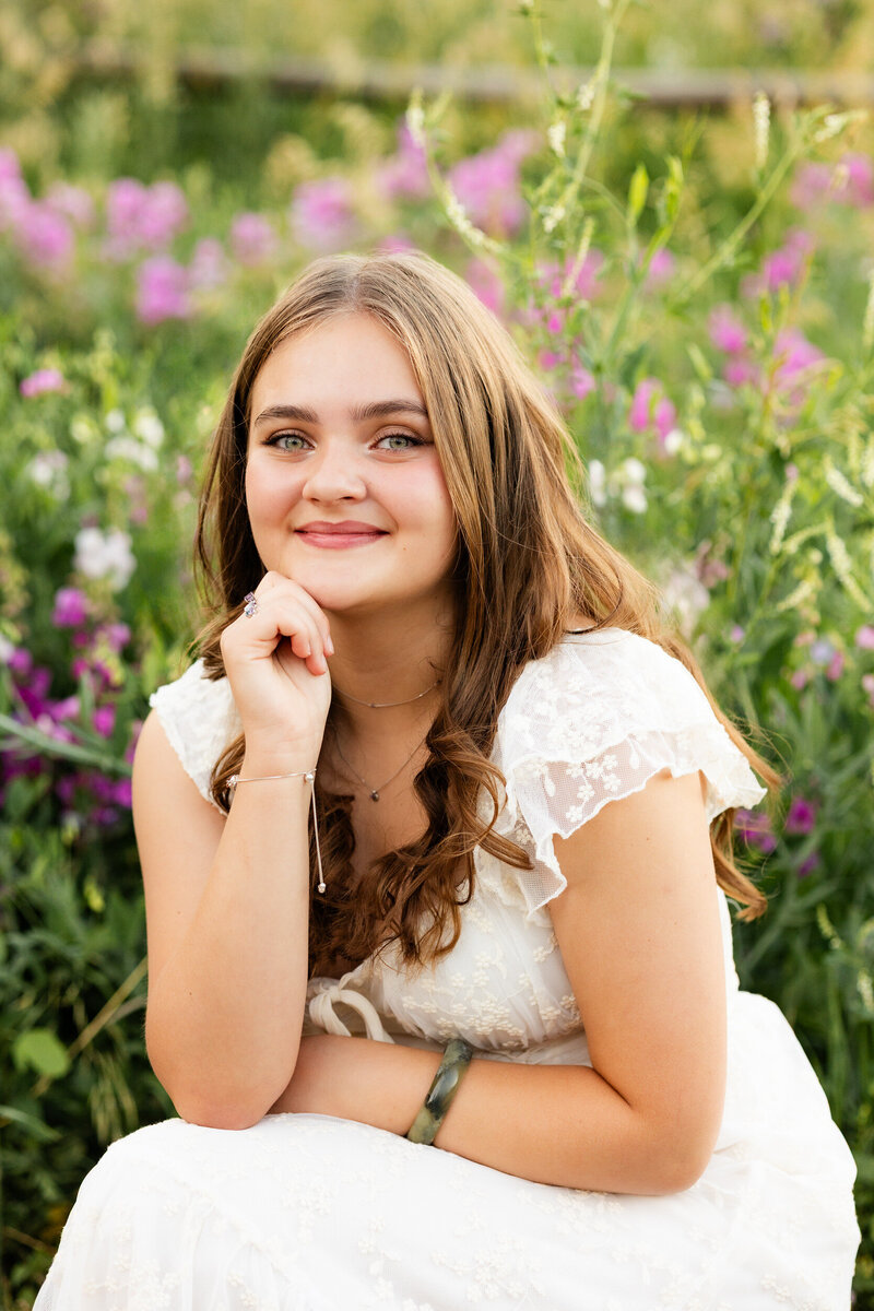 A husband and wife kiss in a sunflower field.
