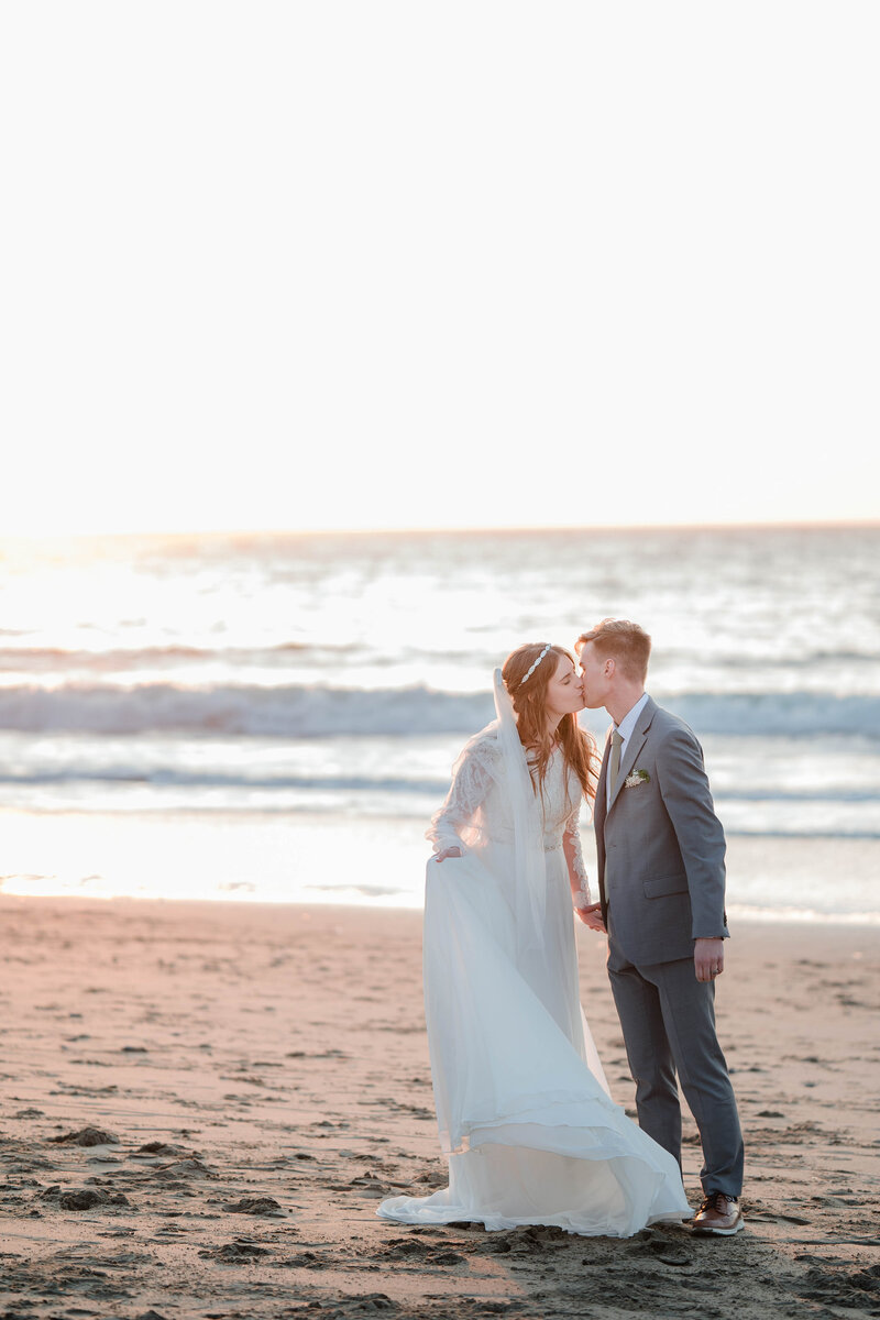 Bride and groom in the golden hour light at Baker Beach in San Fransisco, California