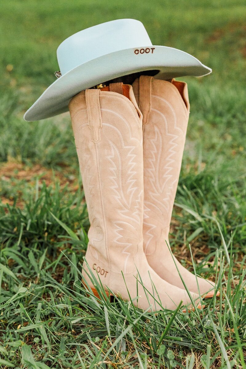 a cowgirl hat on top of cowgirl boots