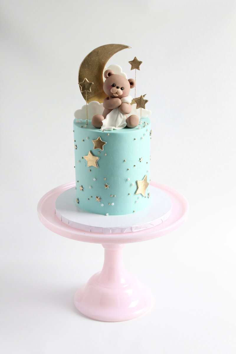Pink cake with frosting and gold butterflies