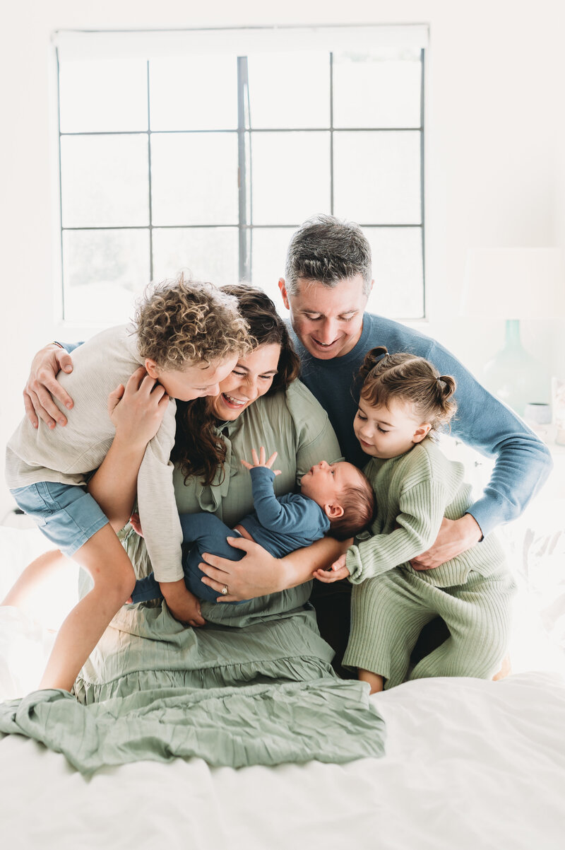 family of five hugging