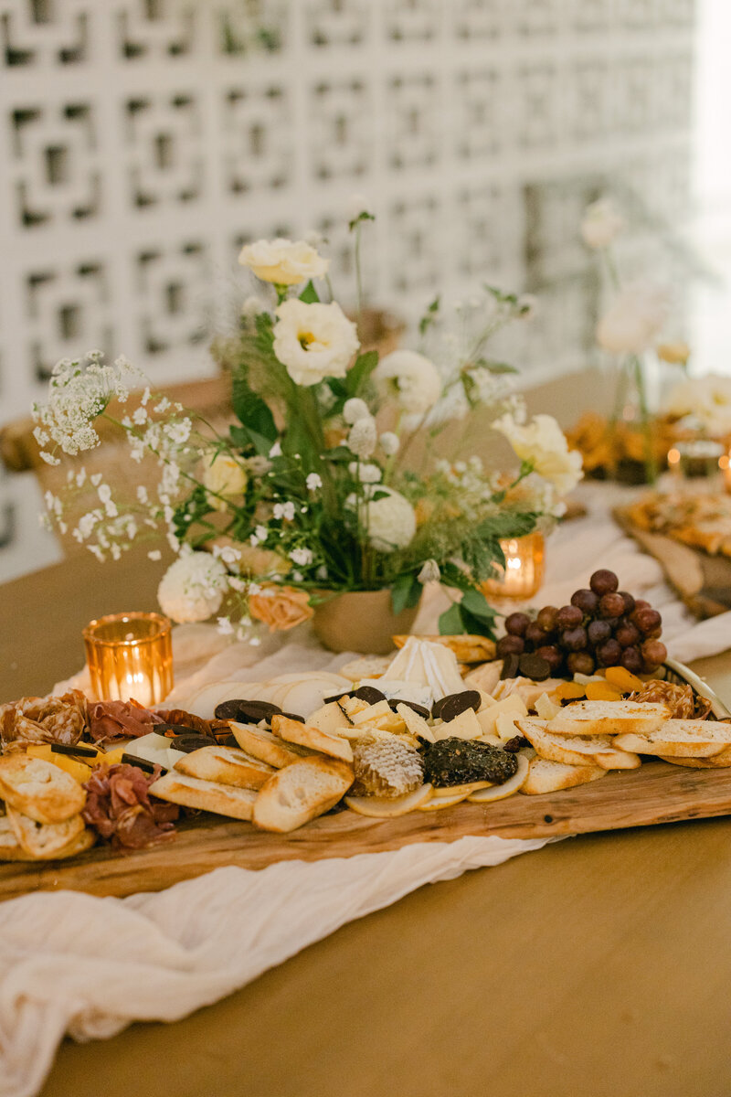 a Chacuterie board featuring all sorts of exotic cheeses, meats, and  grapes--perfect for a quick refreshment during a busy party  