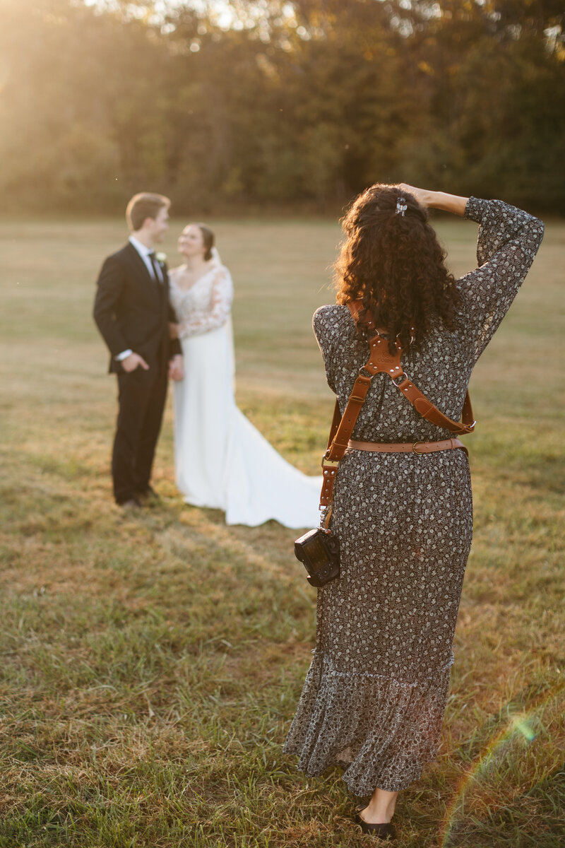 Victoria Barclay, photographer at Through Victoria's Lens, photographing a bride and groom at sunset at their Nashville wedding