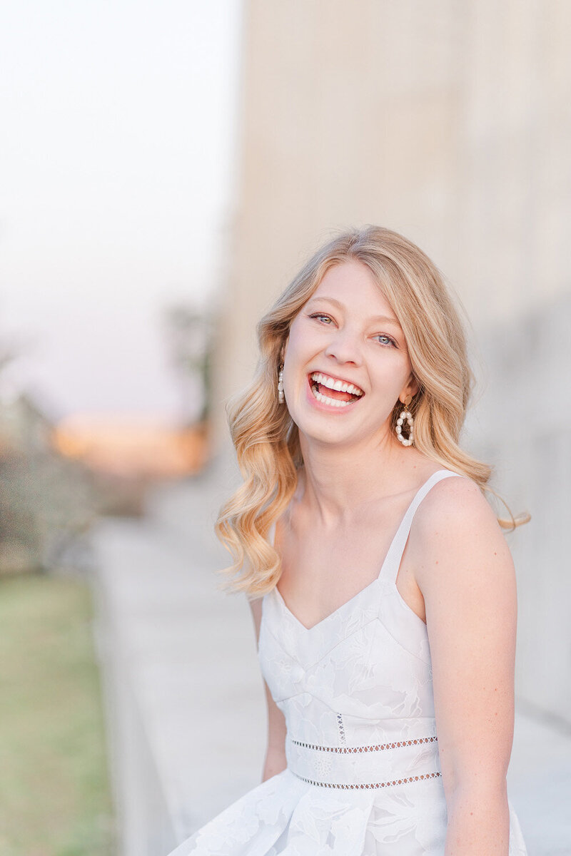 college girl laughing outside the Lincoln Memorial during senior pictures
