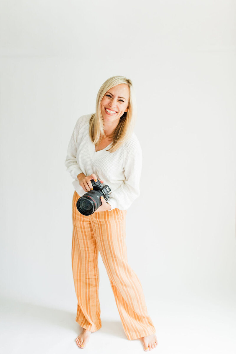 Photography mentor and family photographer based in San Diego, Christine Dammann tosses disco balls in the air.