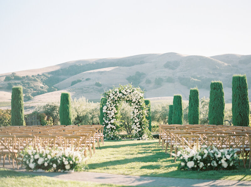 outdoor wedding venue with flowers bushes and landscape with fields