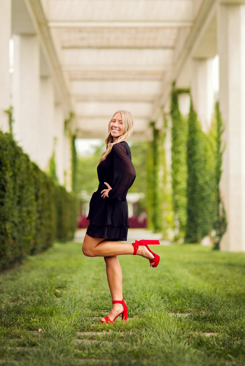 Morristown senior in Columbus , Indiana, with lots of greenery and red shoes to complement her black dress.