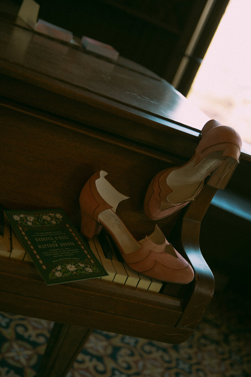 Newlyweds gaze into eachothers eyes on a brisk summer evening while the sun glares between their faces and her veil gets carried in the wind