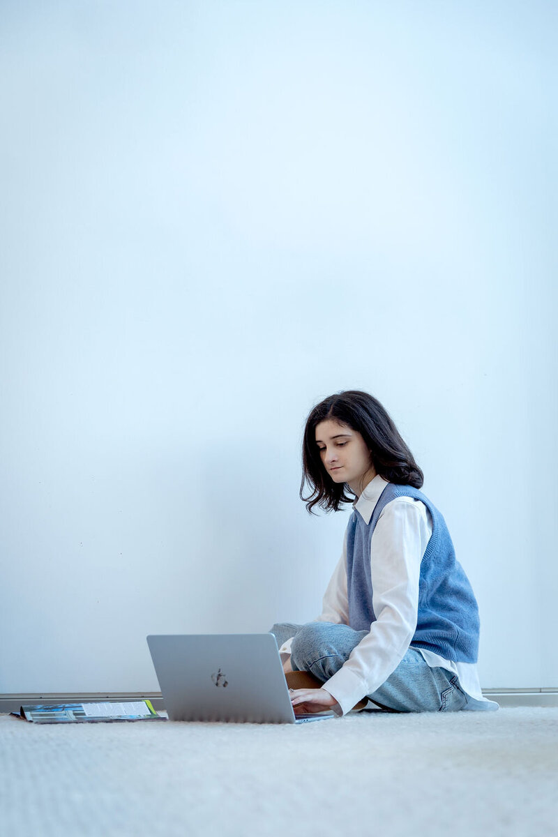 Person sitting on the floor using a laptop