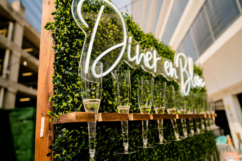 A chic champagne wall at Le Diner En Blanc, Columbia, SC, providing an elegant touch to this stylish, all-white event.