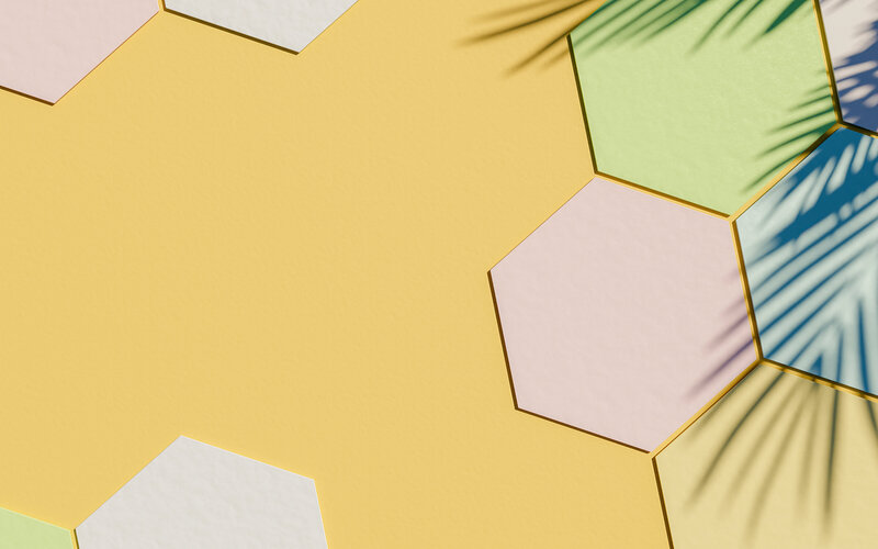 vecteezy_cardboard-hexagons-background-with-pastel-color-and-palm_2264192