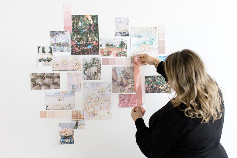 event planner placing items on a bridal collage wall