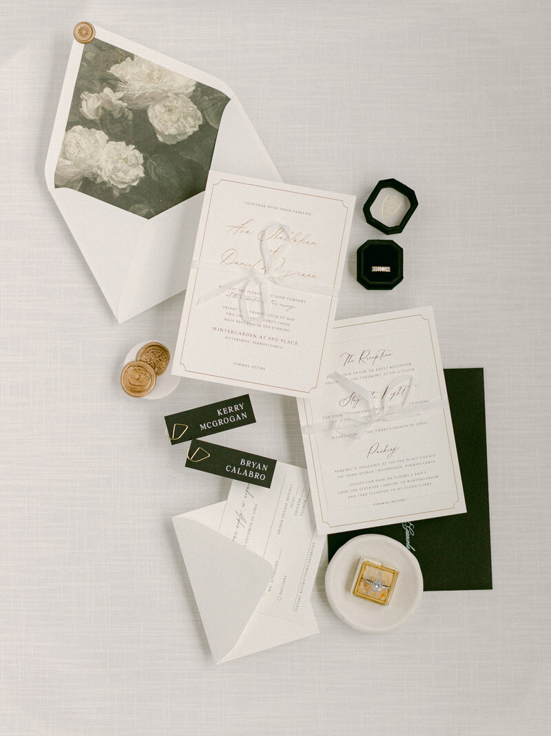 White linen styling mat with vow books and wedding rings for bridal flat lay