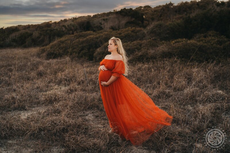 A pregnant woman in a red dress.