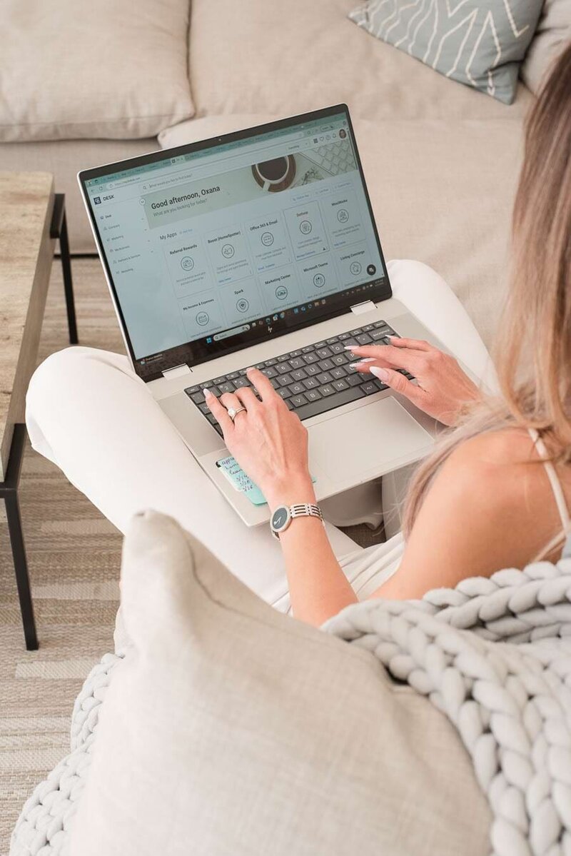 Woman using her laptop to post her marketing material.