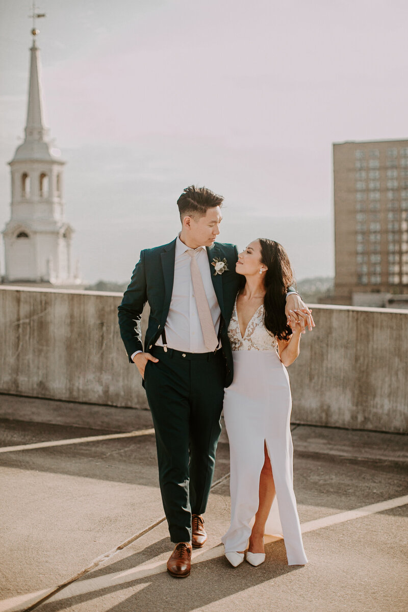 Wedding couple walking on top of parking garage together in Lancaster PA