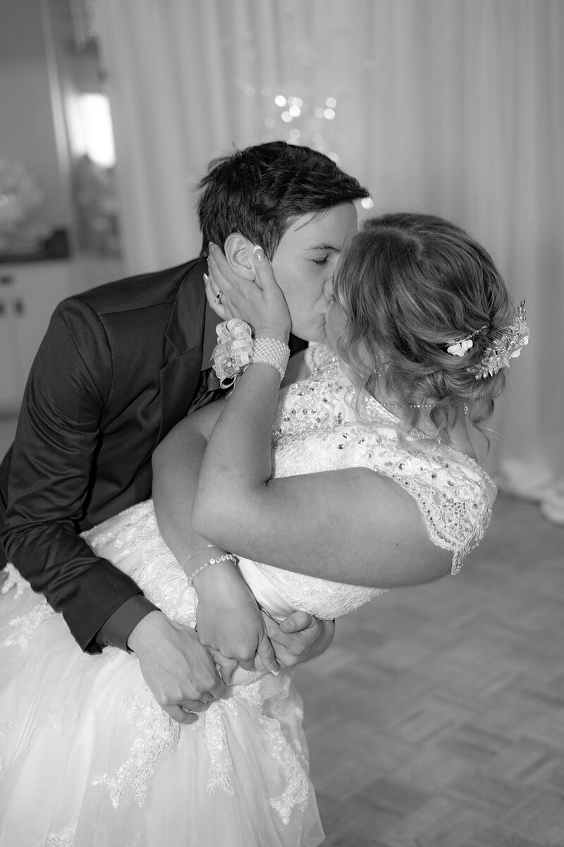 A warm moment of the bride and groom kissing on the dance floor in Denver, Colorado