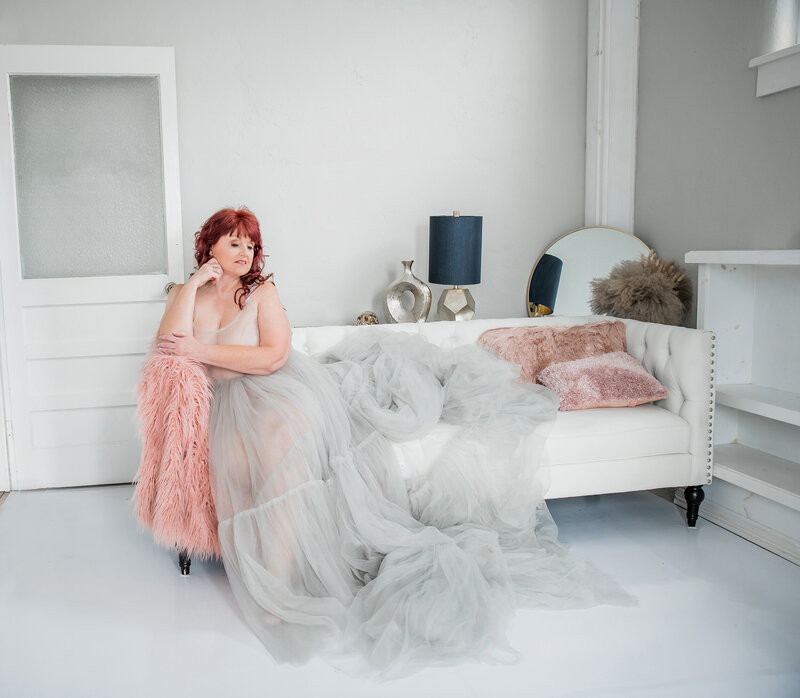 Woman sitting on the couch in a long dress