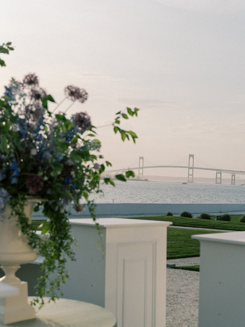 Flower arrangement with bridge in background at sunset