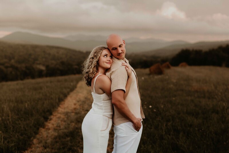 Guy holding girl up and kissing