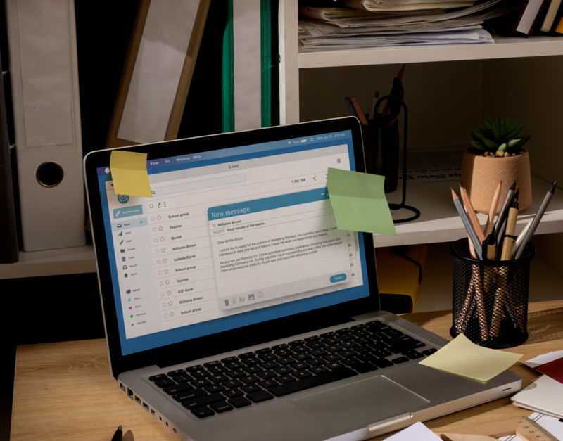 Laptop on a desk with notes