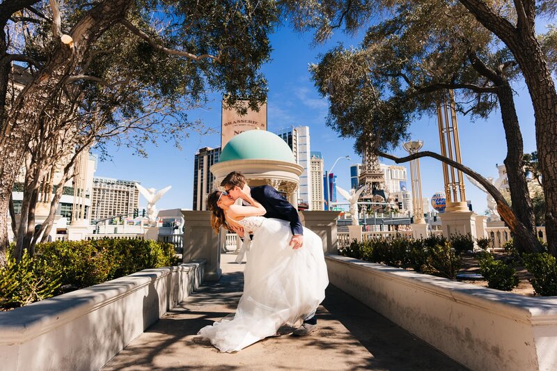 A couple sharing a kiss against a beautiful backdrop of the Las Vegas strip.