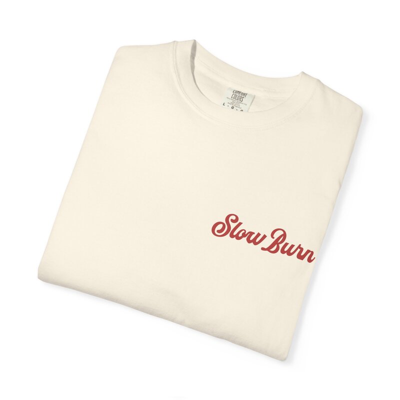 A folded cream and red graphic t-shirt that says slow burn.