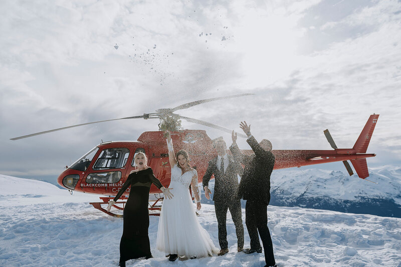 Whistler groom bends down to pet dog after Whistler wedding ceremony