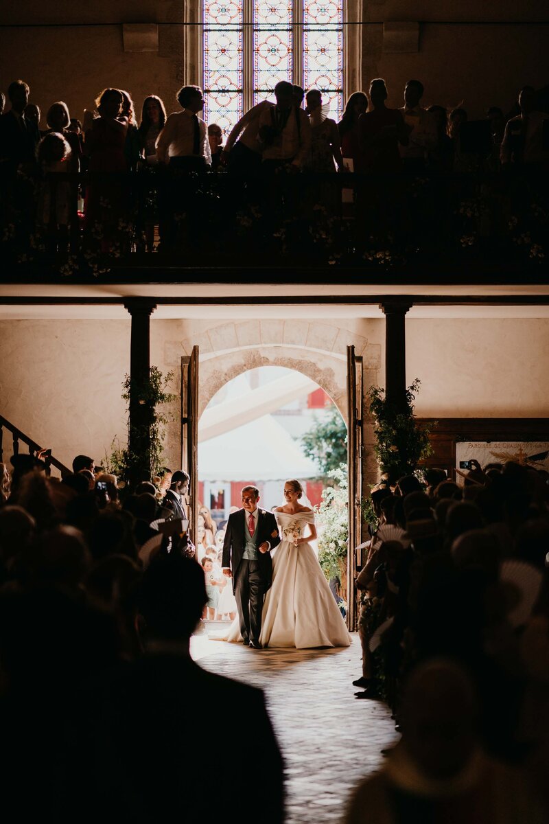 Entrance of father of the bride and bride into French wedding ceremony