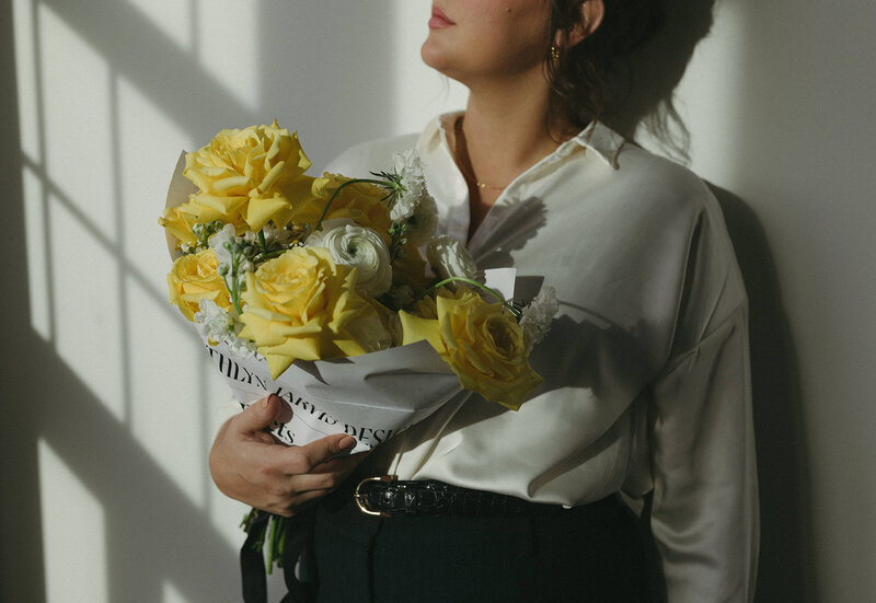 girl wrapped a bouquet in branded paper