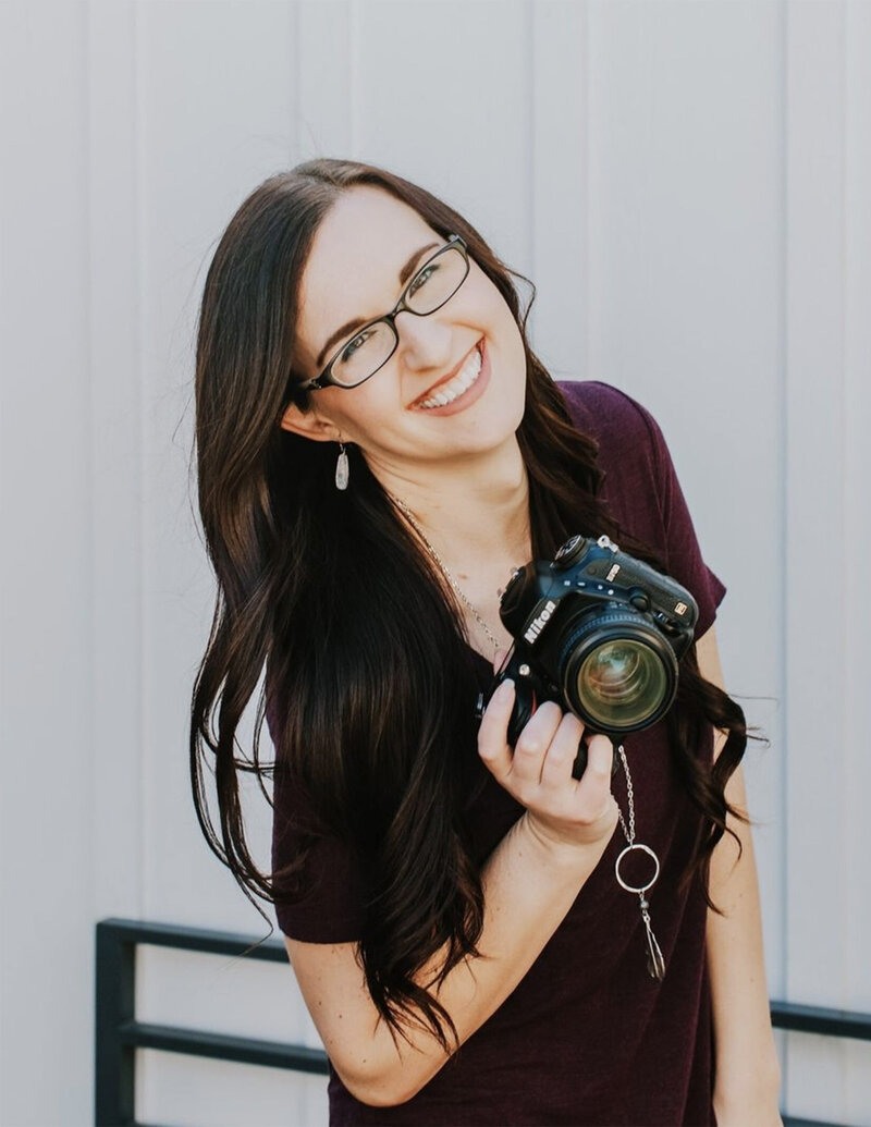 Photographer, Emily, smiles and celebrates with champagne