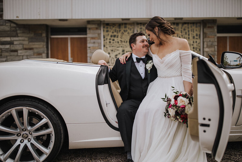A couple sitting together in the passenger seat of a car