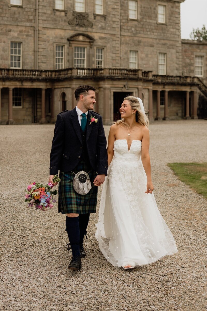 A newly married couple are photographed after their wedding in front of an Aberdeenshire country house.