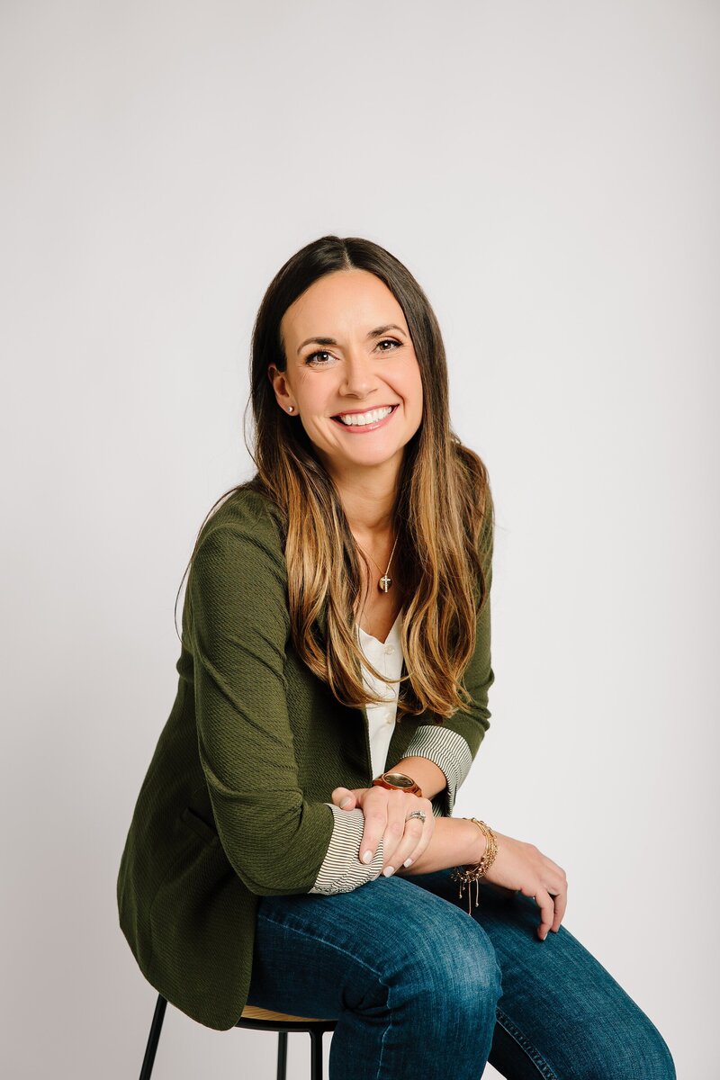 Christina smiling in a green blazer