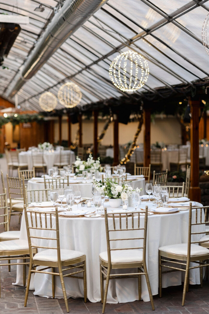 venue set up at madison greenhouse with tables and flowers
