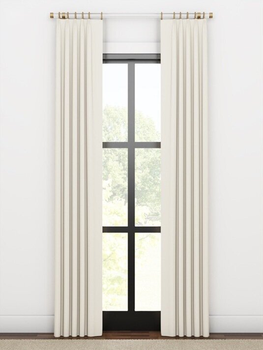 Single-width stationary drapery side panels framing a window